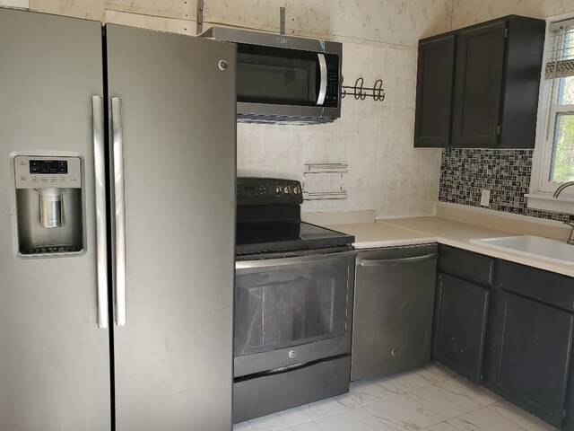 429 S Arnold, Mount Pleasant, MI 48858 - kitchen with a sink, decorative backsplash, marble finish floor, and stainless steel appliances