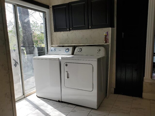 429 S Arnold, Mount Pleasant, MI 48858 - clothes washing area with marble finish floor, cabinet space, and washing machine and dryer