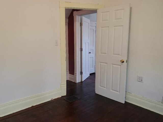 429 S Arnold, Mount Pleasant, MI 48858 - spare room with dark wood-style flooring, baseboards, and visible vents