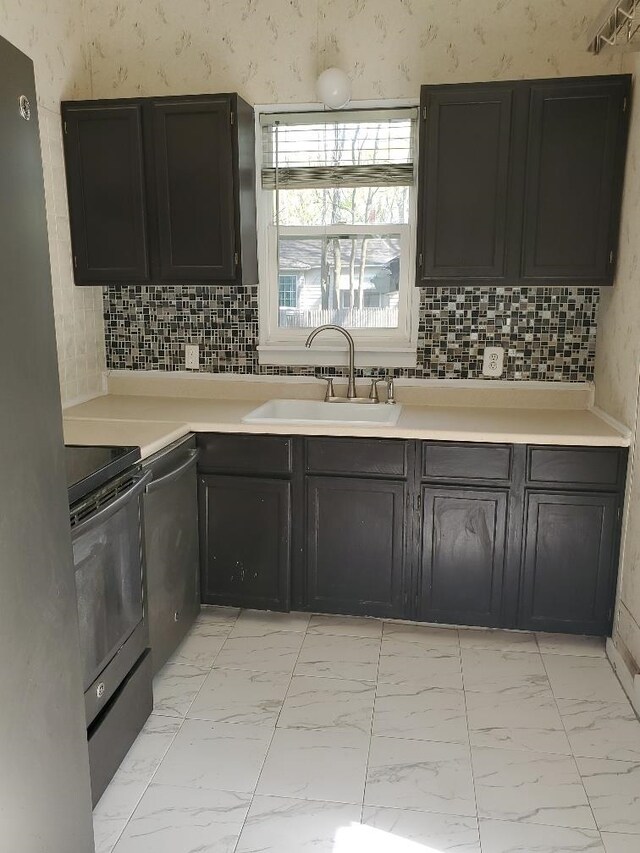 429 S Arnold, Mount Pleasant, MI 48858 - kitchen with a sink, marble finish floor, appliances with stainless steel finishes, and light countertops