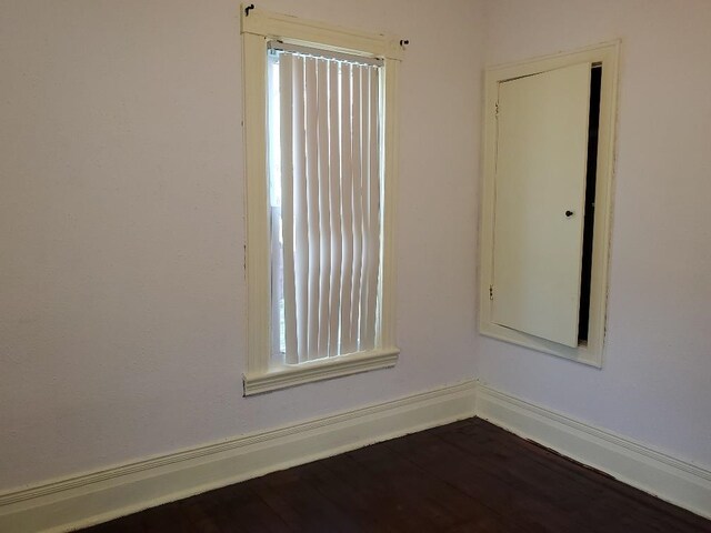 429 S Arnold, Mount Pleasant, MI 48858 - unfurnished room featuring dark wood finished floors and a wealth of natural light