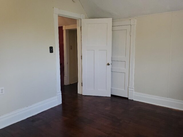 429 S Arnold, Mount Pleasant, MI 48858 - spare room featuring baseboards, dark wood finished floors, and lofted ceiling