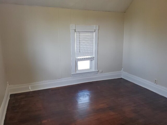 429 S Arnold, Mount Pleasant, MI 48858 - spare room featuring baseboards and dark wood-type flooring