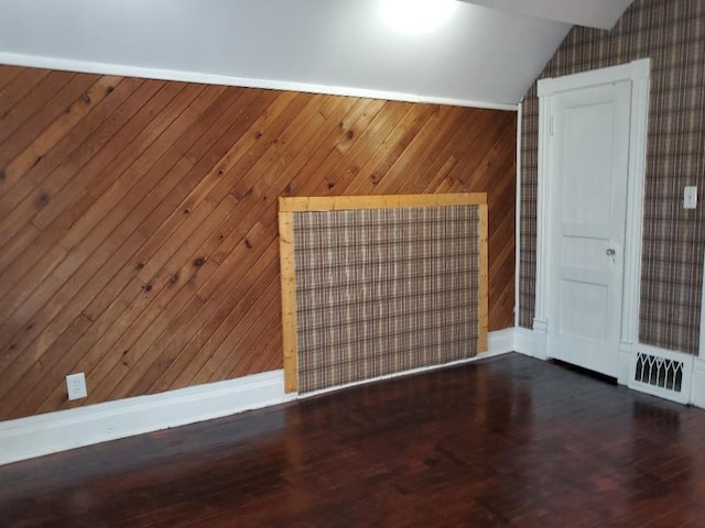 429 S Arnold, Mount Pleasant, MI 48858 - spare room featuring wood walls, wood finished floors, and lofted ceiling