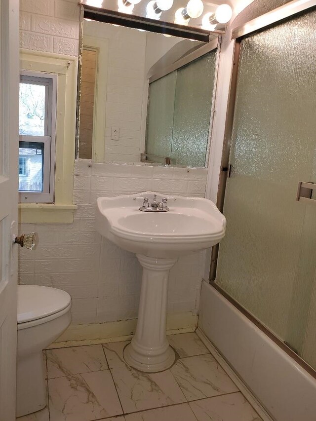 429 S Arnold, Mount Pleasant, MI 48858 - full bath featuring toilet, marble finish floor, and bath / shower combo with glass door