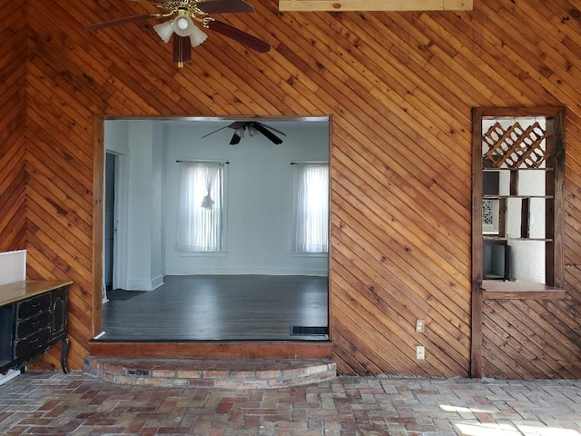 429 S Arnold, Mount Pleasant, MI 48858 - interior space with a ceiling fan, wood walls, and brick floor