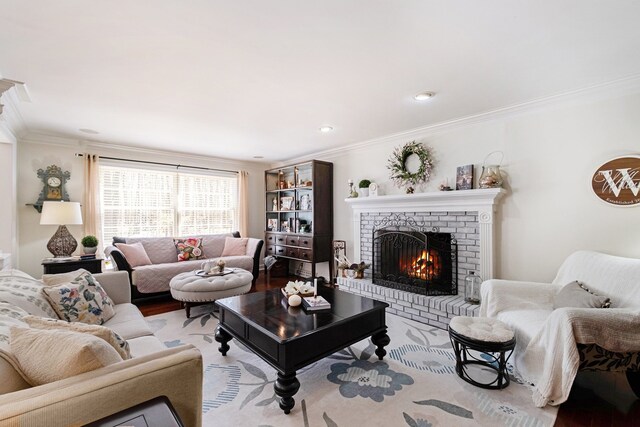 living area with ornamental molding, wood finished floors, and a fireplace