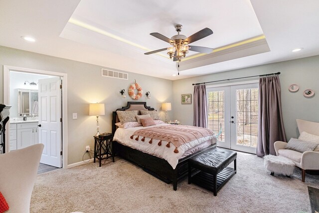 bedroom with access to outside, light colored carpet, french doors, a tray ceiling, and visible vents
