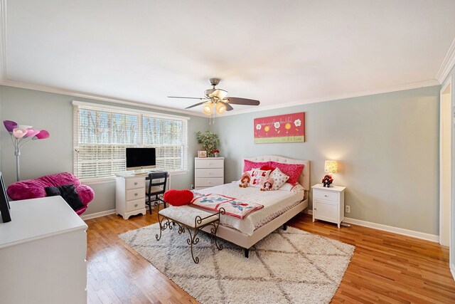 bedroom featuring baseboards, ornamental molding, light wood-type flooring, and ceiling fan