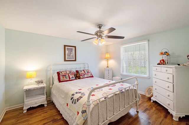 bedroom featuring baseboards, ceiling fan, and wood finished floors