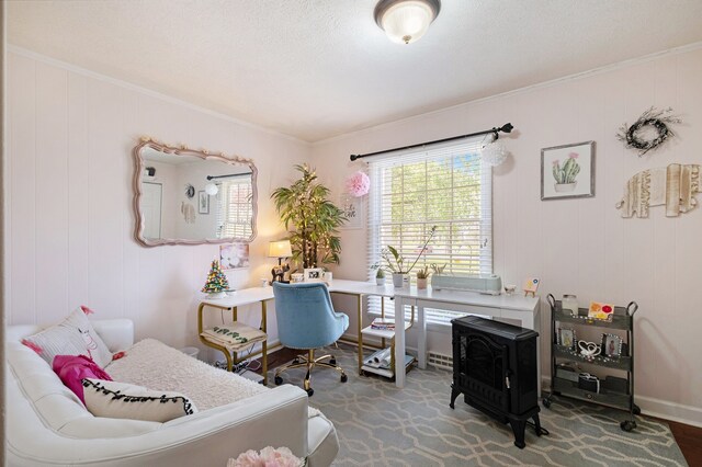 bedroom with crown molding, a wood stove, baseboards, and multiple windows