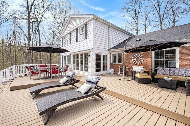 wooden deck with outdoor dining area and an outdoor hangout area