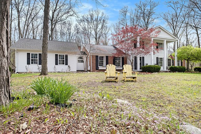 rear view of house with a lawn