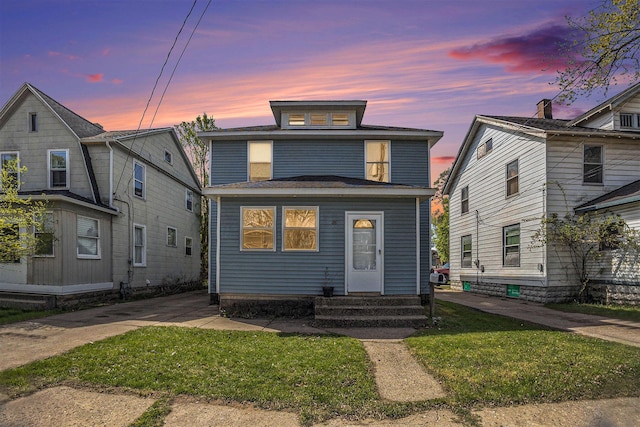 traditional style home with entry steps and a front yard
