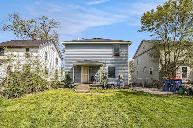 rear view of property with fence, a patio, and a yard