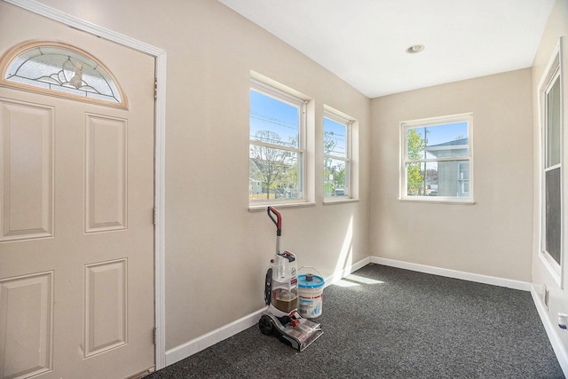 carpeted foyer entrance with baseboards