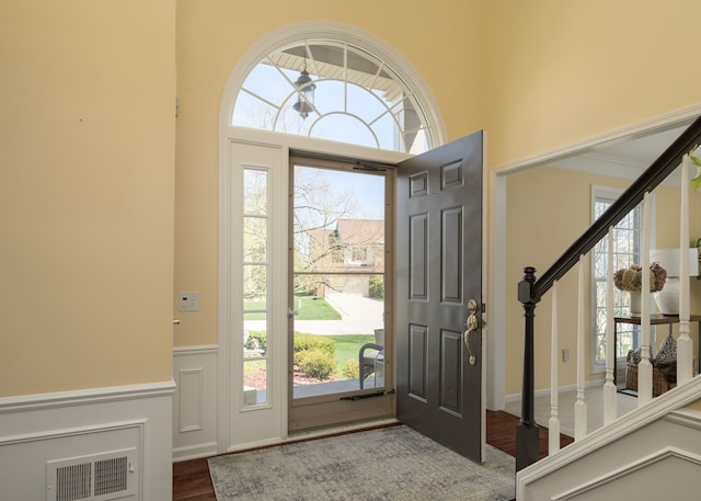 1699 Devonwood Dr, Rochester Hills, MI 48306 - foyer featuring visible vents, a decorative wall, wood finished floors, stairway, and a wainscoted wall