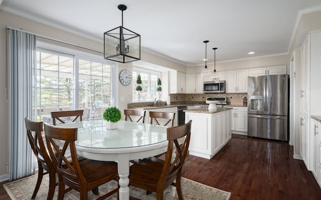 1699 Devonwood Dr, Rochester Hills, MI 48306 - dining space with crown molding, recessed lighting, an inviting chandelier, and dark wood-style floors