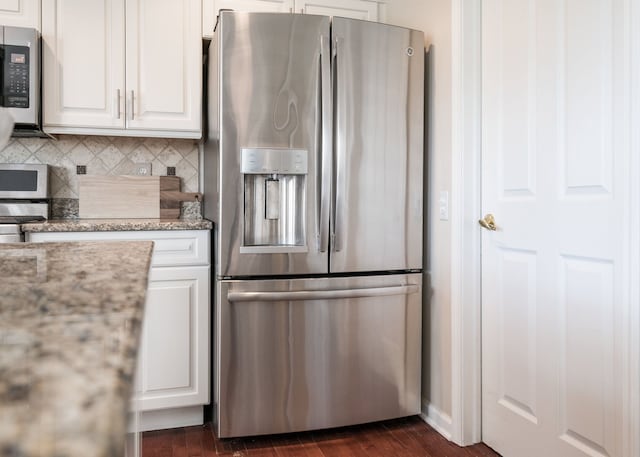 1699 Devonwood Dr, Rochester Hills, MI 48306 - kitchen featuring white cabinets, light stone counters, dark wood finished floors, appliances with stainless steel finishes, and backsplash