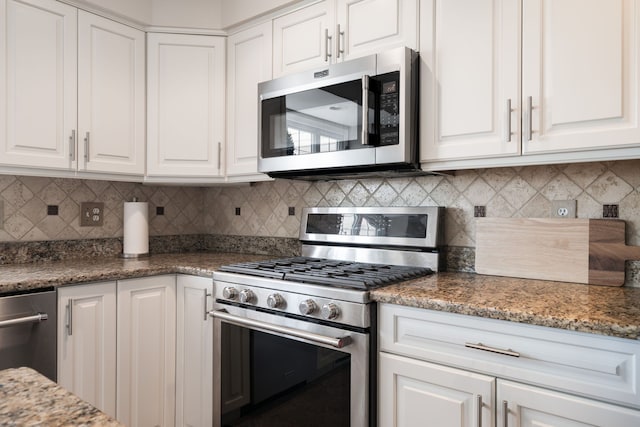 1699 Devonwood Dr, Rochester Hills, MI 48306 - kitchen featuring white cabinetry, light stone countertops, appliances with stainless steel finishes, and decorative backsplash
