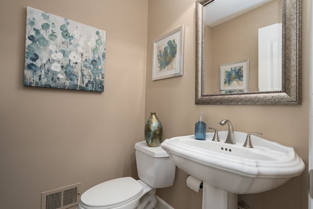 1699 Devonwood Dr, Rochester Hills, MI 48306 - bathroom with a sink, baseboards, toilet, and visible vents