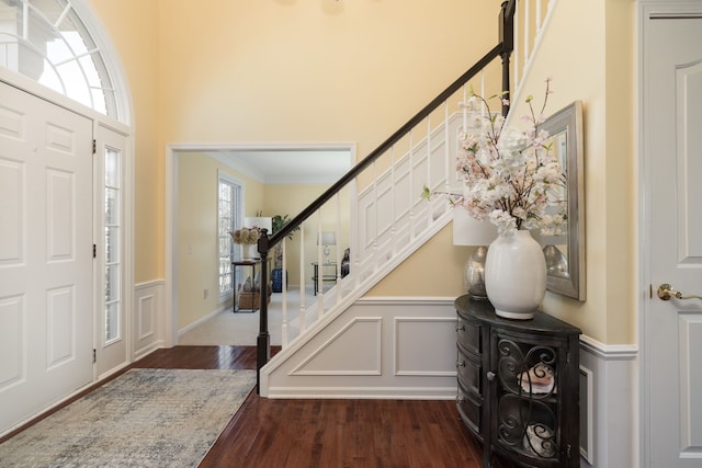 1699 Devonwood Dr, Rochester Hills, MI 48306 - entrance foyer featuring crown molding, a wainscoted wall, stairway, and dark wood-type flooring