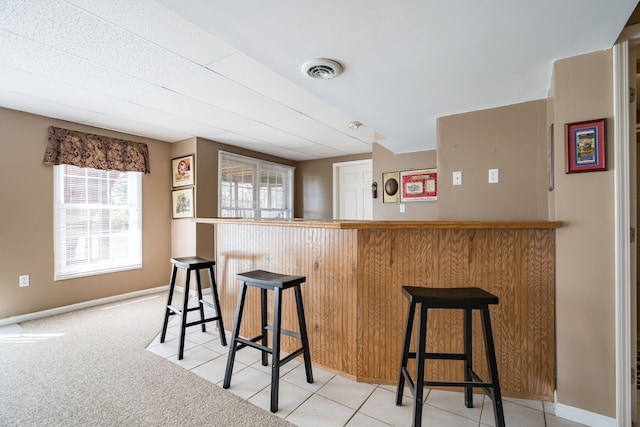 1699 Devonwood Dr, Rochester Hills, MI 48306 - bar with baseboards, visible vents, and bar