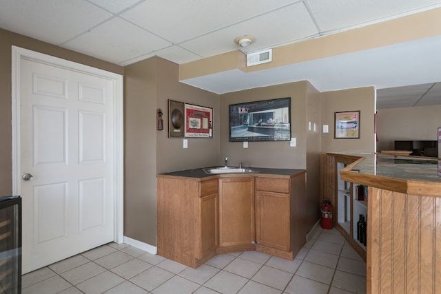 1699 Devonwood Dr, Rochester Hills, MI 48306 - kitchen with a sink, light tile patterned floors, visible vents, and a paneled ceiling
