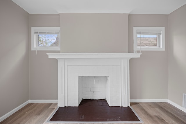 15866 Woodingham Dr, Detroit, MI 48238 - room details featuring baseboards, wood finished floors, visible vents, and a fireplace