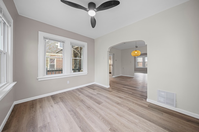 15866 Woodingham Dr, Detroit, MI 48238 - unfurnished room with ceiling fan, visible vents, arched walkways, baseboards, and light wood-style floors