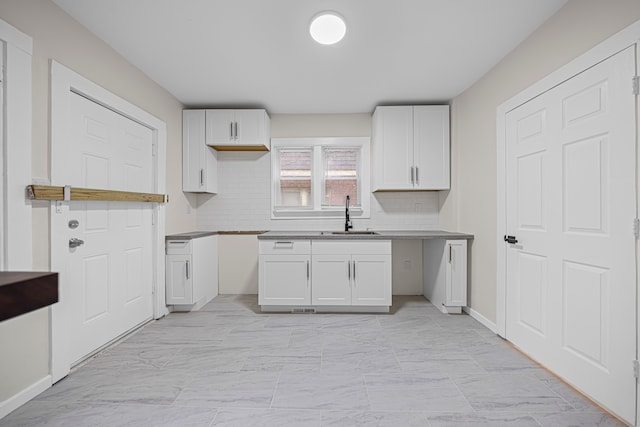 15866 Woodingham Dr, Detroit, MI 48238 - kitchen with a sink, decorative backsplash, marble finish floor, and white cabinets