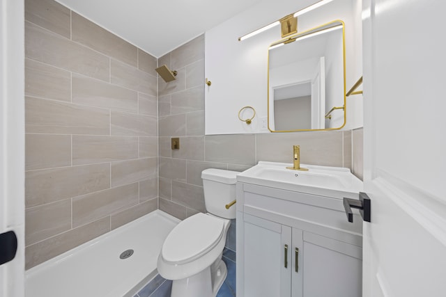 15866 Woodingham Dr, Detroit, MI 48238 - bathroom featuring vanity, toilet, tiled shower, and tile walls