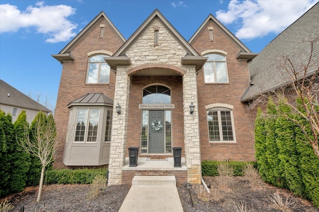 french country home with brick siding