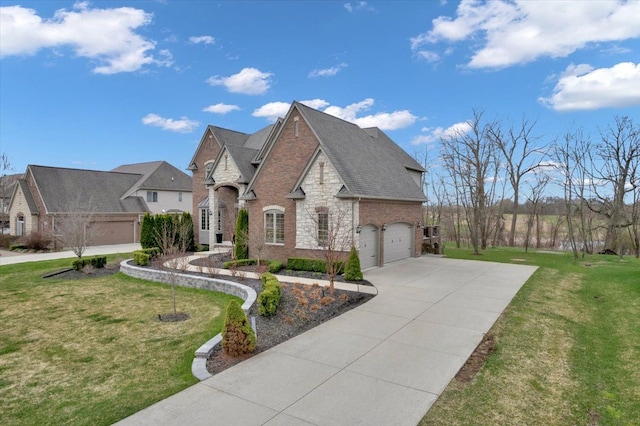 view of front of home with concrete driveway, brick siding, an attached garage, and a front yard