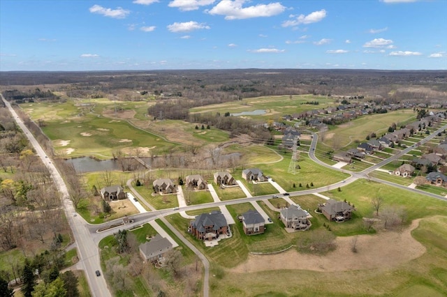 drone / aerial view featuring a water view, golf course view, and a residential view