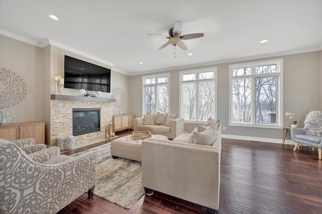 living room with crown molding, a fireplace, baseboards, ceiling fan, and dark wood-style floors