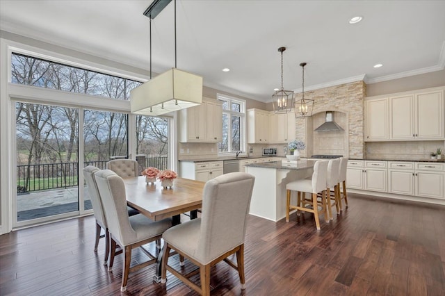 dining room with recessed lighting, ornamental molding, and dark wood-style floors