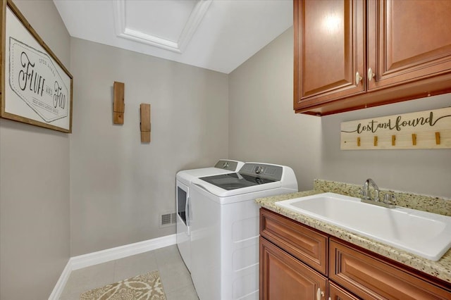 laundry area featuring independent washer and dryer, cabinet space, a sink, baseboards, and light tile patterned floors