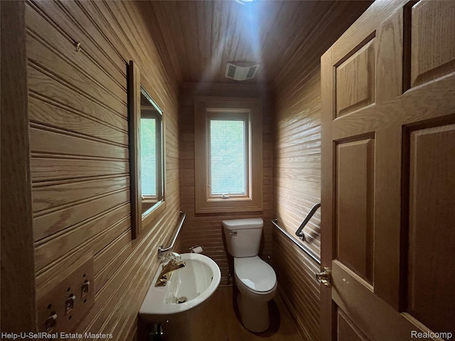 3015 E Village Ln, Port Huron, MI 48060 - half bathroom with toilet, wooden walls, wooden ceiling, and a sink