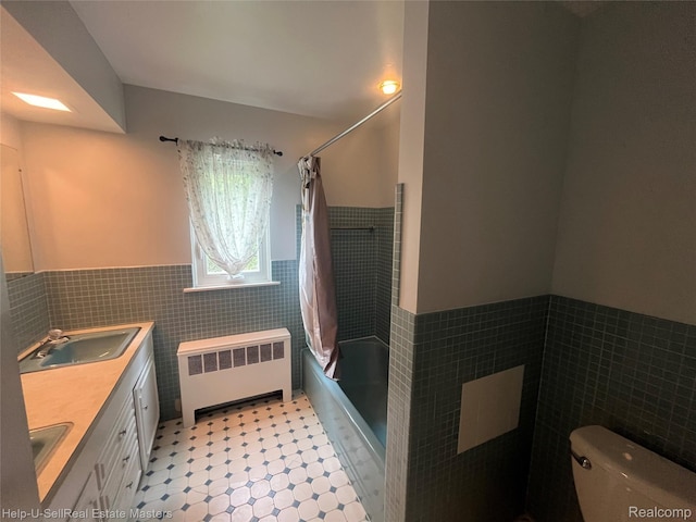 3015 E Village Ln, Port Huron, MI 48060 - full bath featuring radiator, tile walls, wainscoting, toilet, and shower / bath combo with shower curtain