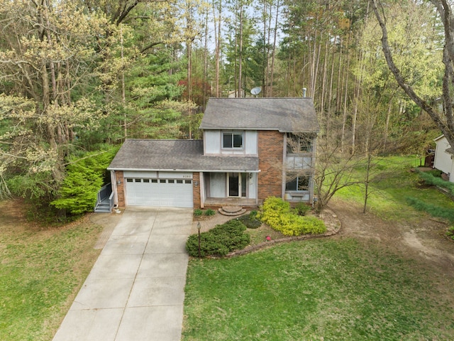 traditional-style home featuring a shingled roof, an attached garage, a front lawn, brick siding, and concrete driveway