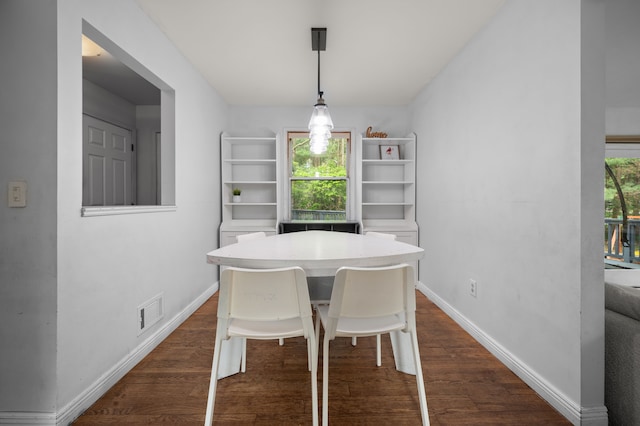 dining room featuring baseboards, dark wood-style floors, and visible vents