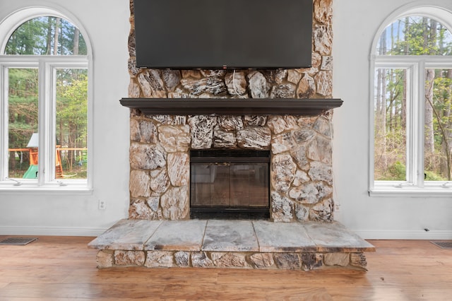 interior details featuring baseboards, wood finished floors, and visible vents