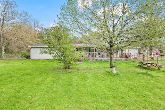 view of yard with fence and a deck