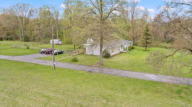 exterior space with a wooded view and aphalt driveway