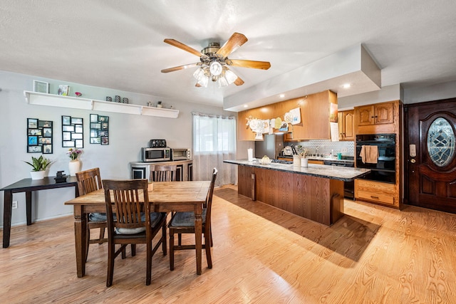 dining area with recessed lighting, ceiling fan, and light wood finished floors
