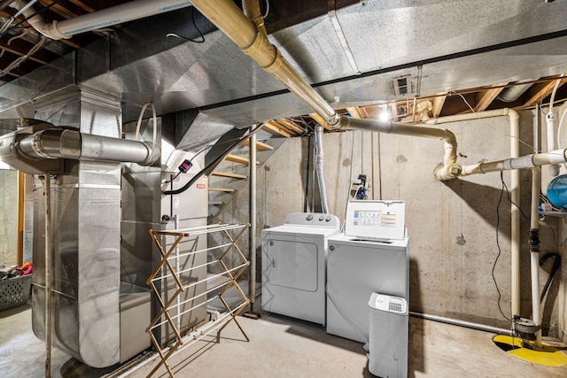 unfinished basement with washing machine and clothes dryer
