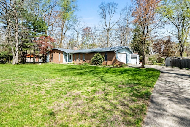 ranch-style house with a garage, brick siding, fence, a front lawn, and concrete driveway