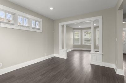 interior space with recessed lighting, baseboards, decorative columns, and dark wood finished floors