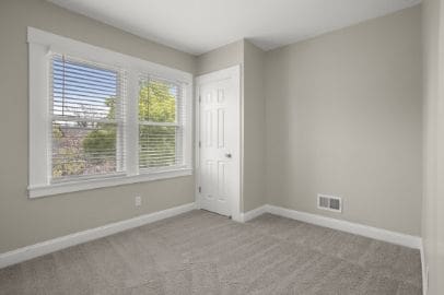 empty room featuring baseboards, carpet flooring, and visible vents